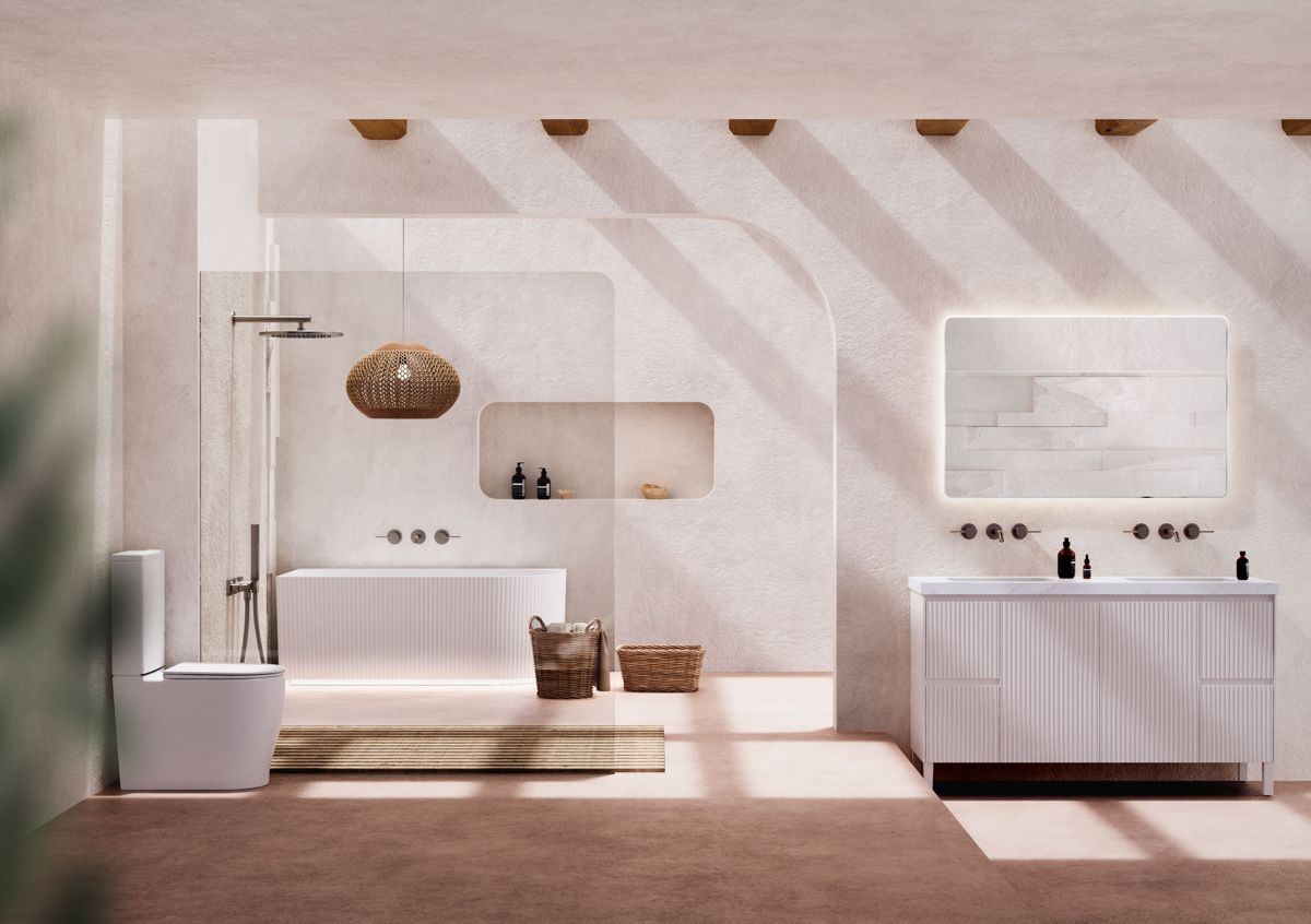 A styled bathroom with a fluted vanity, toilet and freestanding bath
