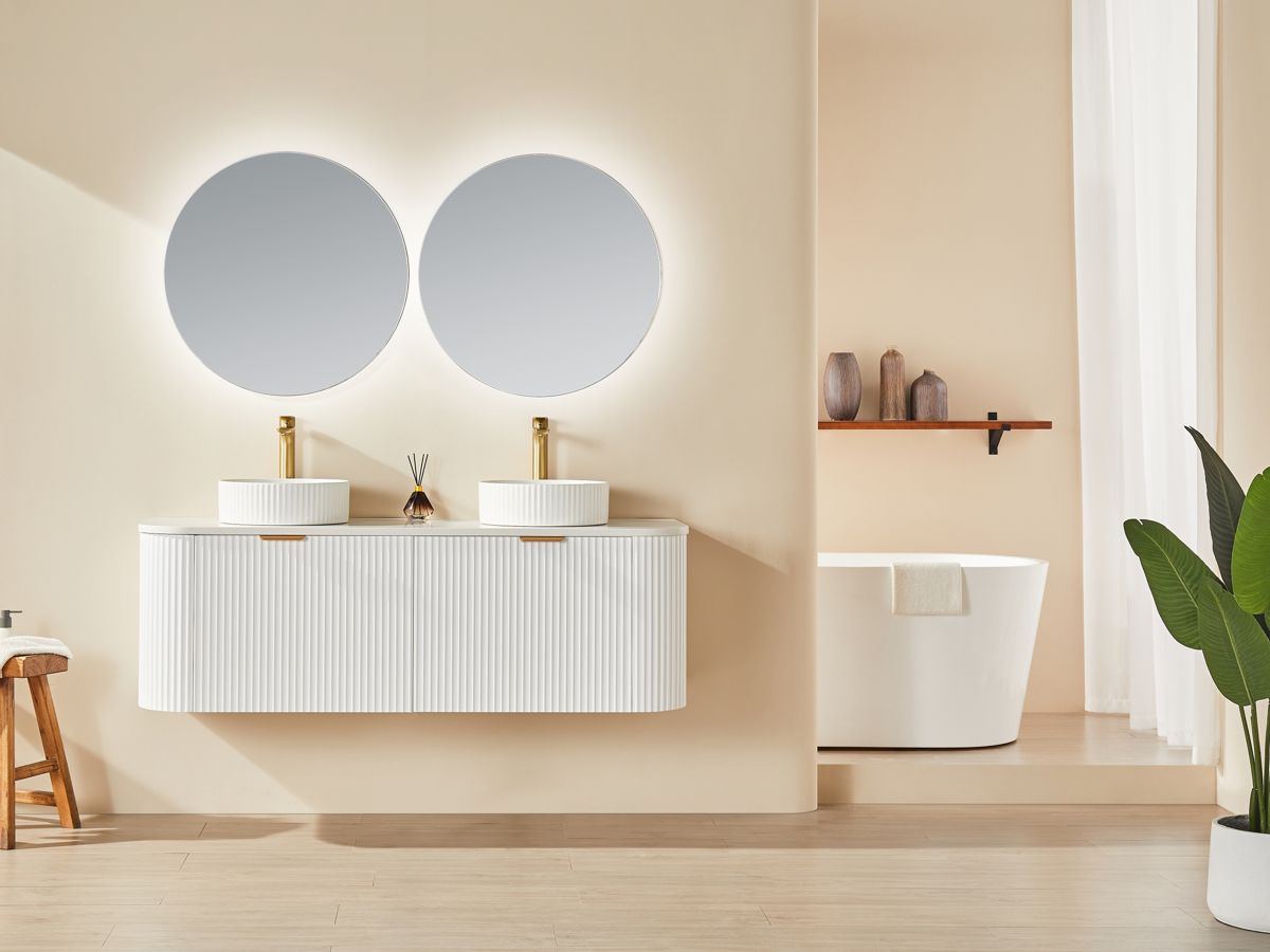 Avalon curved wall-hung vanity beneath a round LED mirror