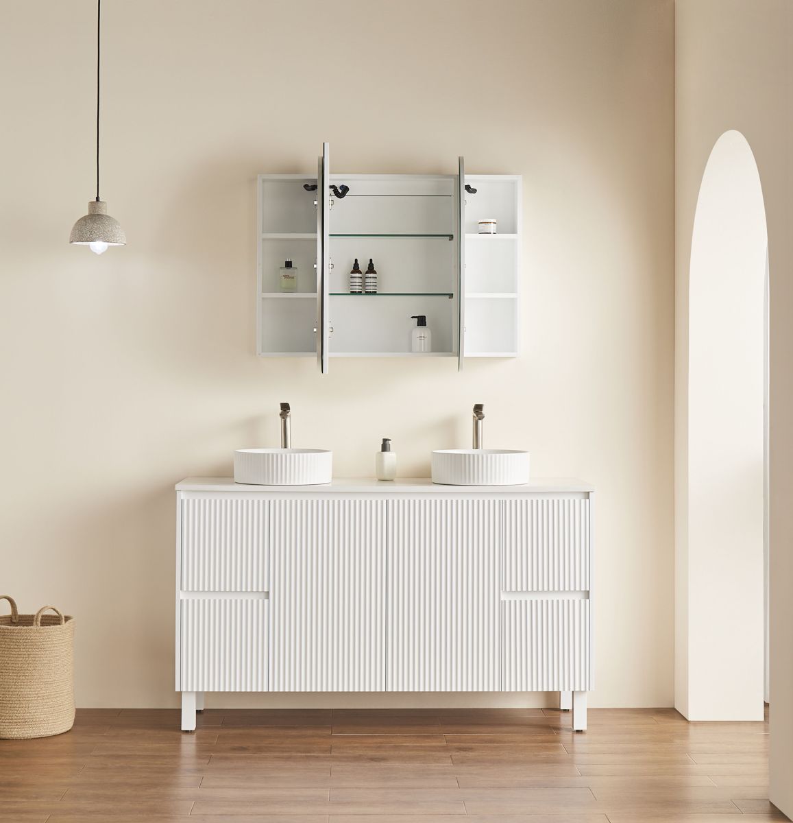 Oval LED shaving cabinet open above a double-basin vanity